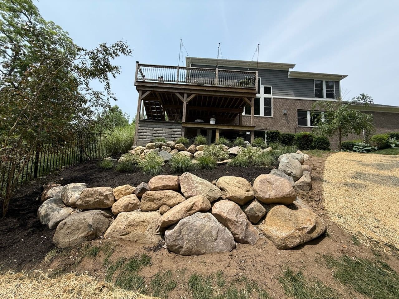 Natural Stone Retaining Wall Beautifies Hillside image